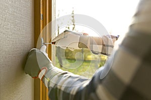 Handyman fixing the window with screwdriver