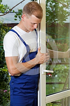 Handyman fixing a window wing