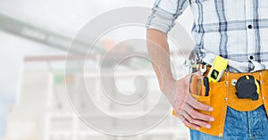 Handyman with hands on hip and tool belt