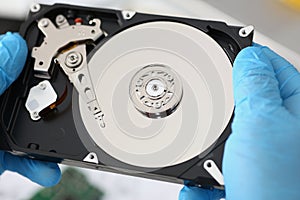 Handyman hold disassembled hard drive from computer, hdd and reader