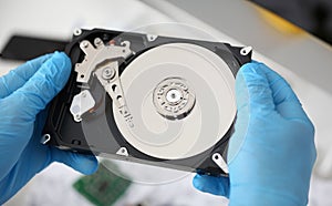 Handyman hold disassembled hard drive from computer, hdd and reader