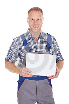 Handyman holding blank placard