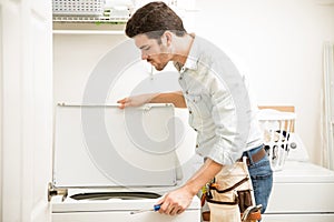 Handyman inspecting a washer