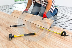 Handyman installing new laminated floor