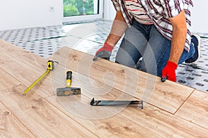 Handyman installing new laminated floor