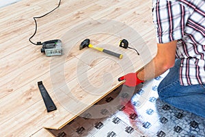 Handyman installing new laminated floor