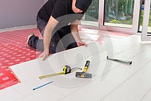 Handyman installing new laminated floor