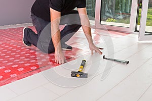 Handyman installing new laminated floor