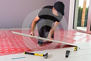 Handyman installing new laminated floor