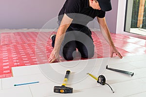 Handyman installing new laminated floor