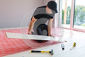 Handyman installing new laminated floor