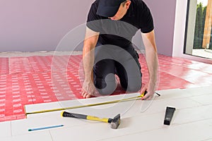 Handyman installing new laminated floor