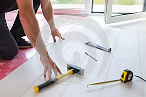 Handyman installing new laminated floor