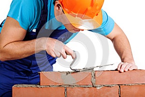 Handyman installing red brick