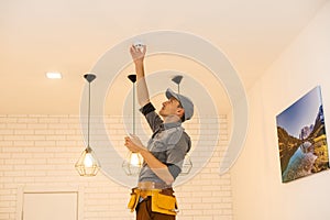 Handyman installing a smoke detector on the ceiling