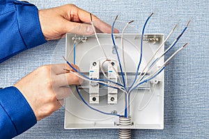 Handyman installs circuit breakers for home wiring