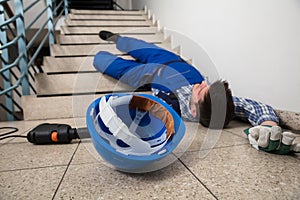 Handyman Lying On Staircase