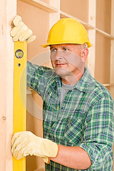 Handyman mature professional with spirit level