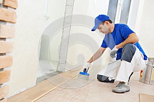 Parquet worker adding glue on floor