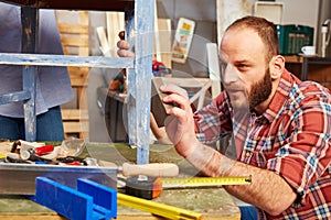 Handyman polishing wooden surface