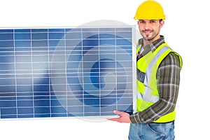 Handyman in protective clothing carrying solar panel