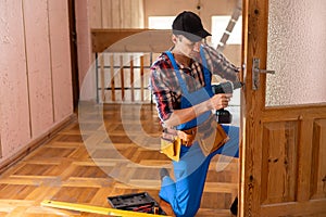handyman repair the door lock in the room.