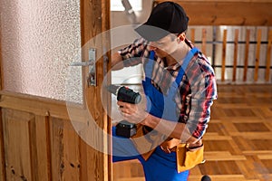 handyman repair the door lock in the room