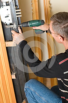 Handyman repairing lock