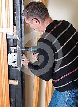 Handyman repairing lock