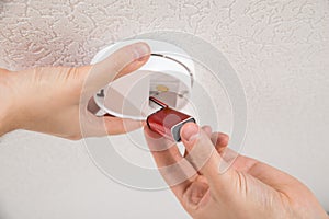 Handyman Repairing Smoke Detector photo