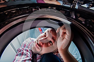 Handyman Repairing Washing Machine in the bathroom