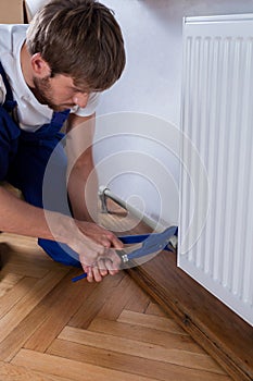 Handyman during repairs radiator