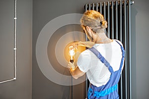 Handyman replacing lightbulb at home