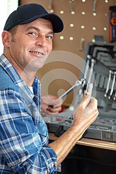 handyman sitting and holding toolbox