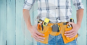 Handyman with tool belt at home