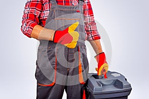 Handyman with tool box showing the thumbs up sign. Copy space.
