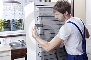 Handyman trying to move a fridge