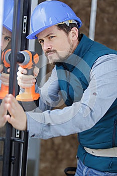 handyman using cordless screwdriver