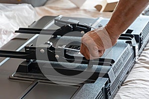Handyman using a screwdriver to fix a window handle tv