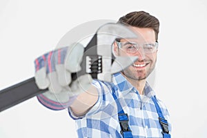 Handyman wearing protective glasses while holding wrench
