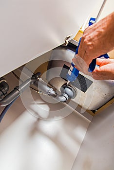 Handyman working in the kitchen on sink