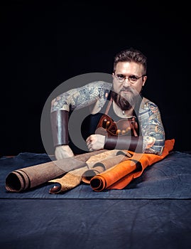 Artisan works with leather goods in the studio