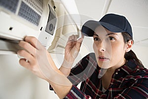 handywoman cleaning fixing ventilation system