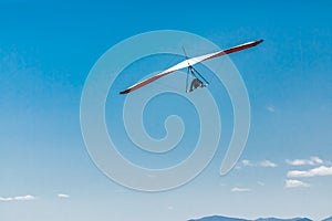 Hang glider flight against the blue sky