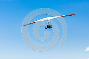 Hang glider flight against the blue sky