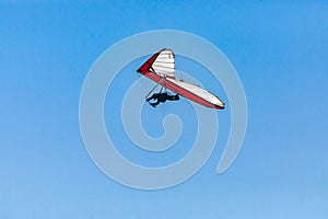 Hang glider flight against the blue sky