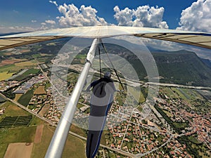 Hang glider pilot flies high over alpine terrain in Provance, Fr