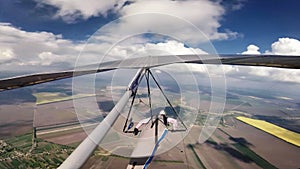 Hang glider pilot race between clouds on high altitude