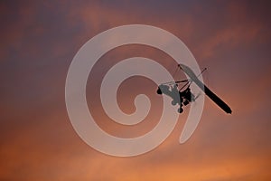 Hang-glider with pilot in sky