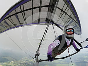 Hang glider pilot under the cloud